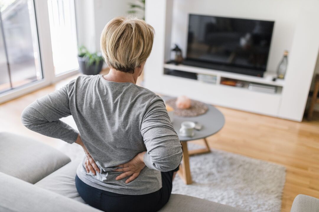 A woman is worried about back pain in the lumbar region